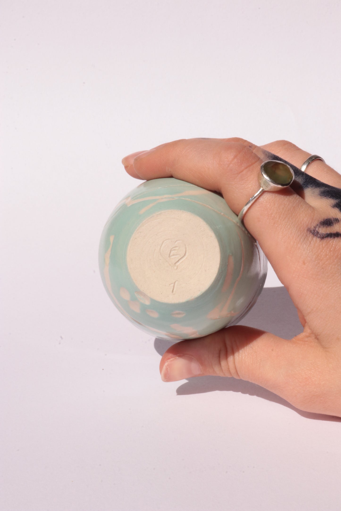 engraved light blue ceramic cup on white background