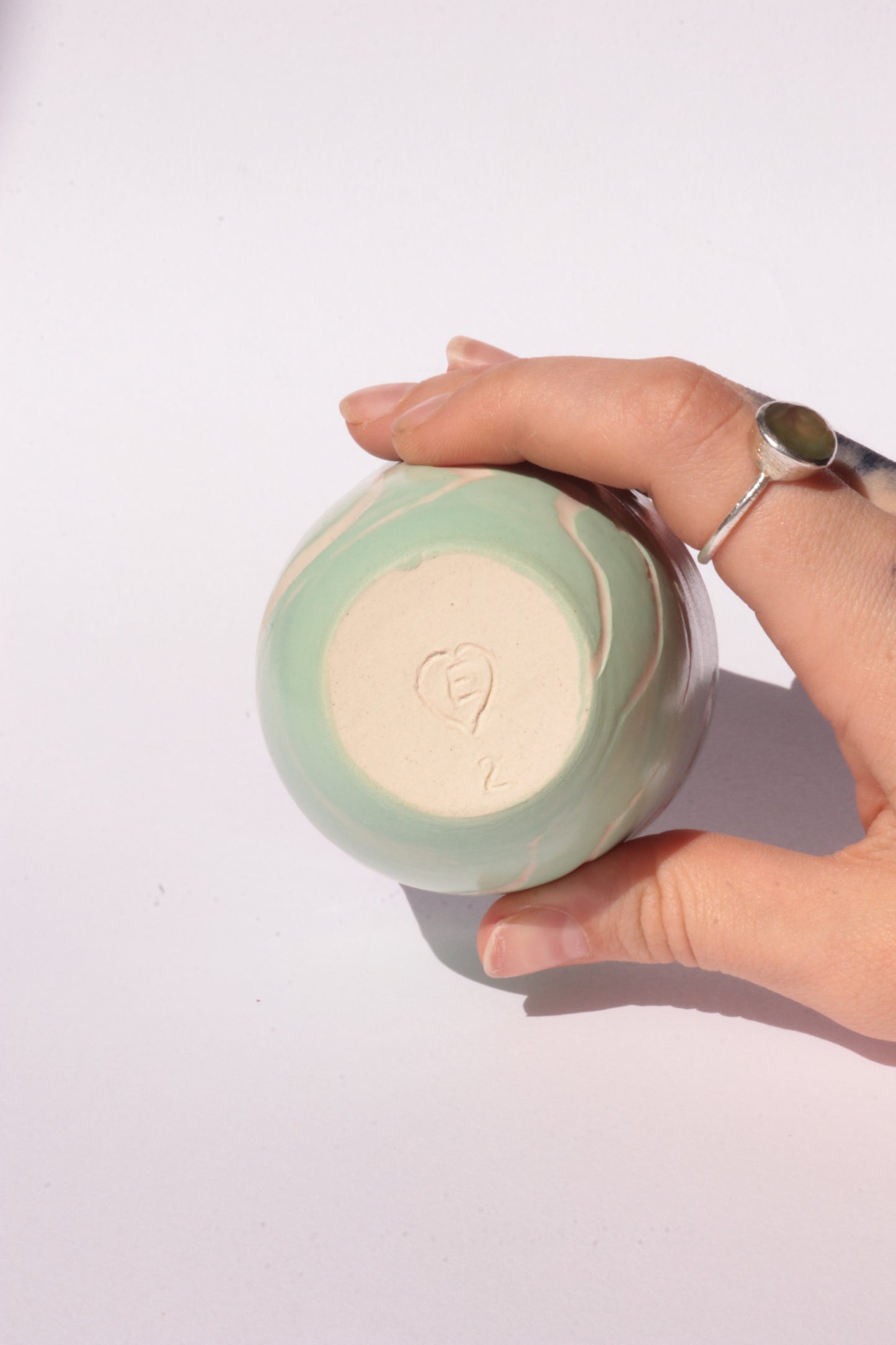 engraved light blue ceramic cup on white background