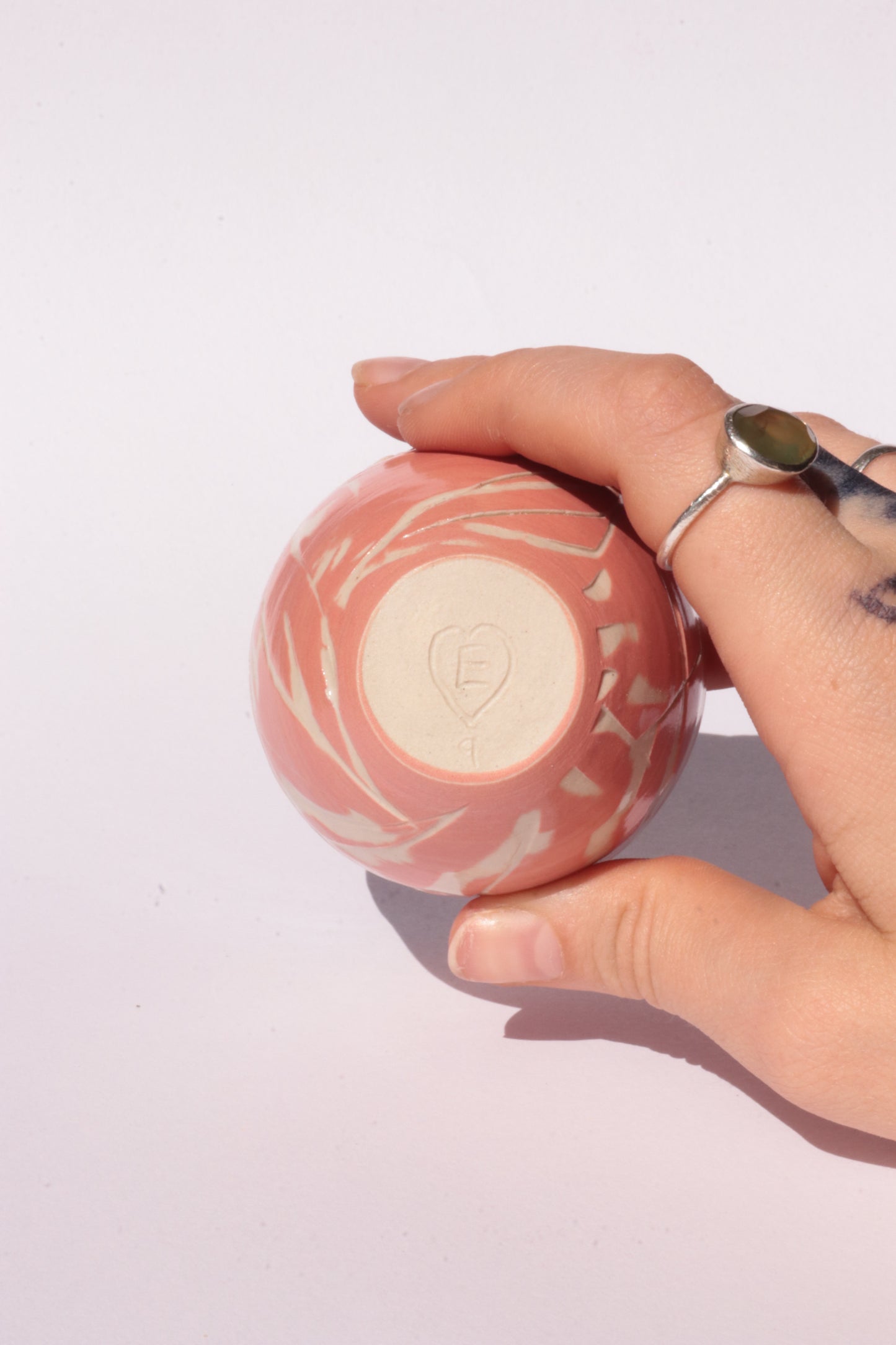 engraved orange ceramic cup on white background