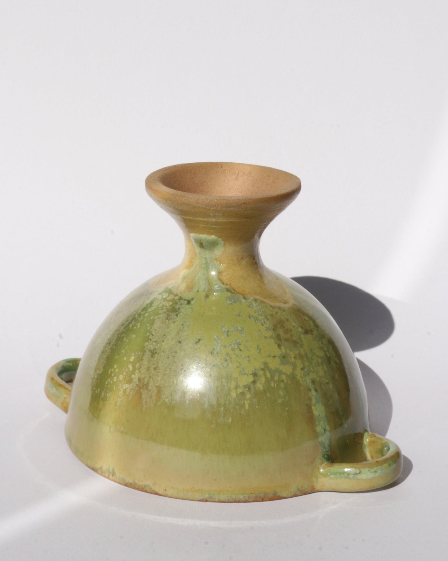 Green ceramic footed bowl on a white background