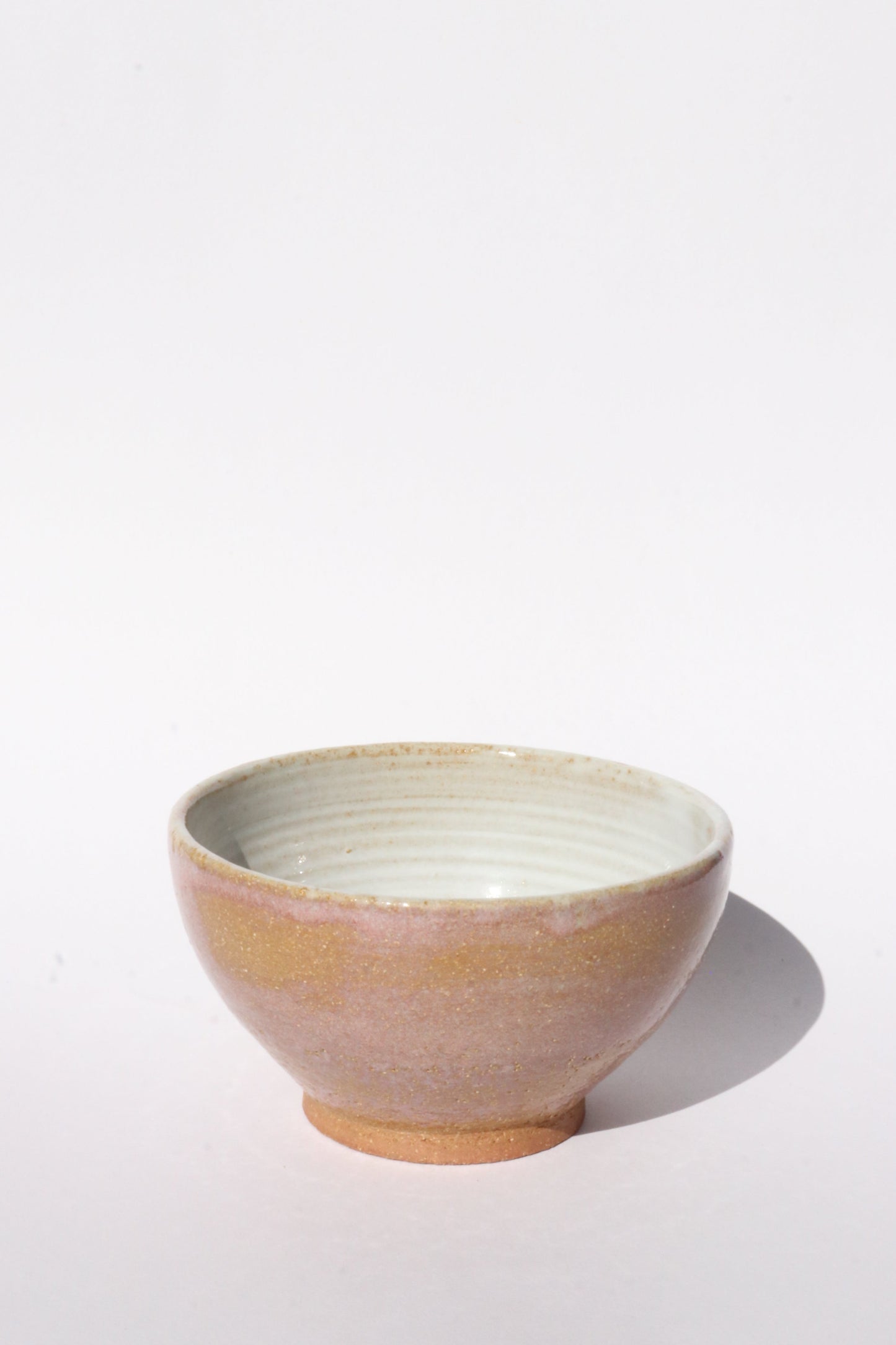 Ceramic brown and pink bowl on white background