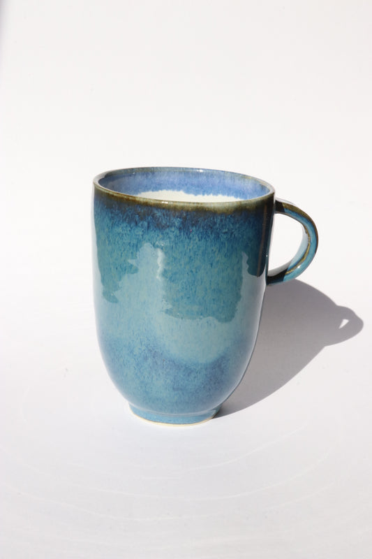 Dark blue ceramic mug on a white background