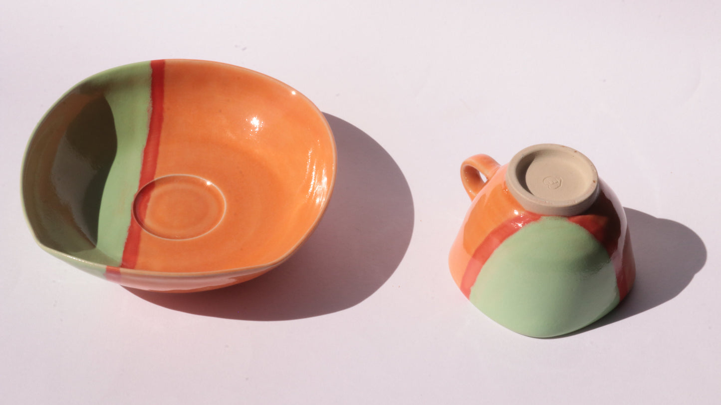 Colorful ceramic plate and cup on a white background