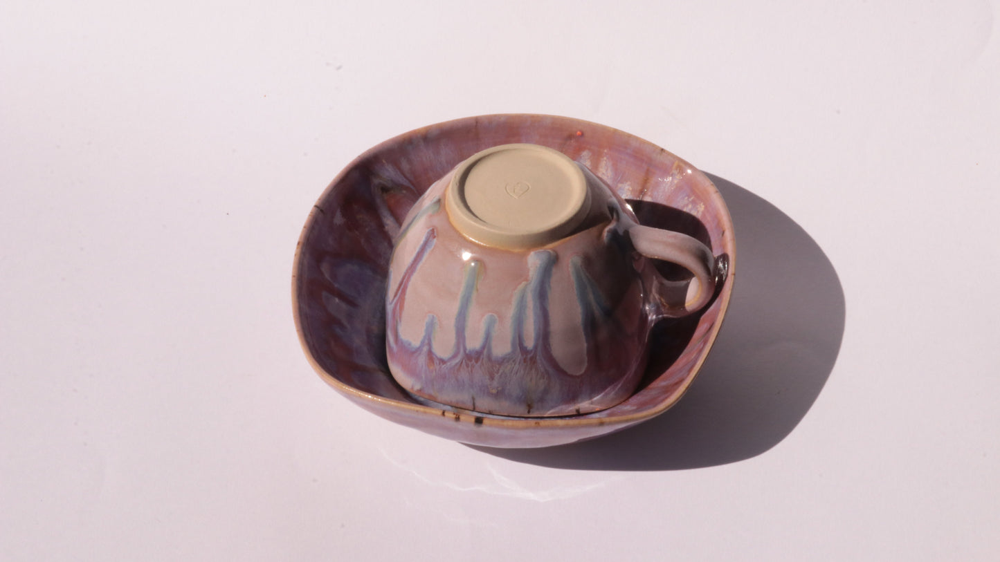 purple coffee cup and saucer with square rims on white background