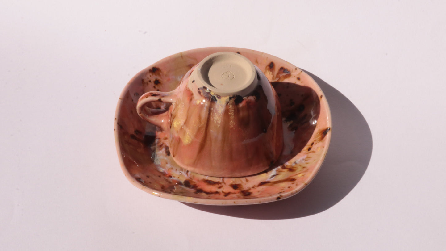 Orange and Pink coffee cup and saucer with square rims on white background