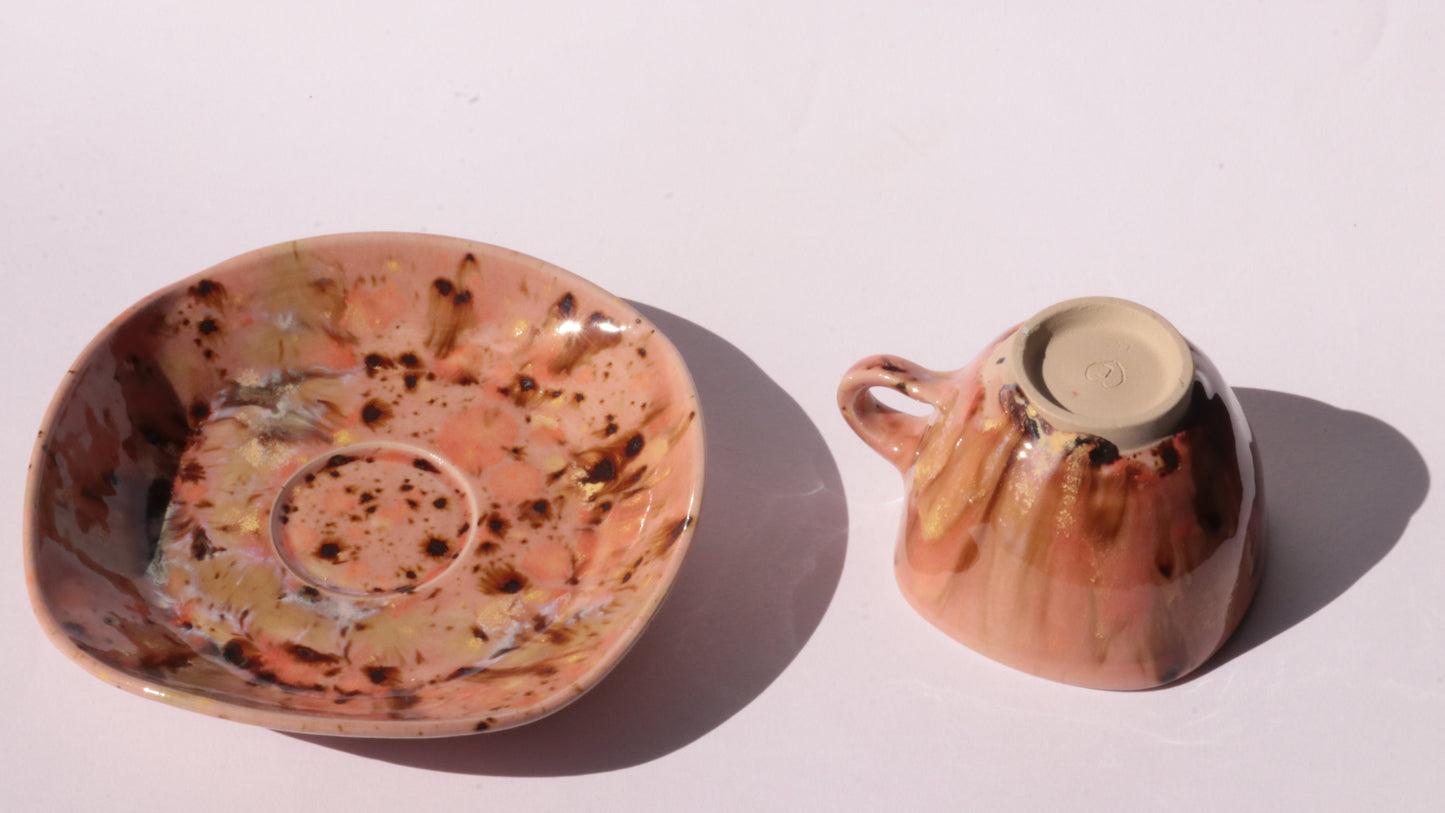 Orange and Pink coffee cup and saucer with square rims on white background