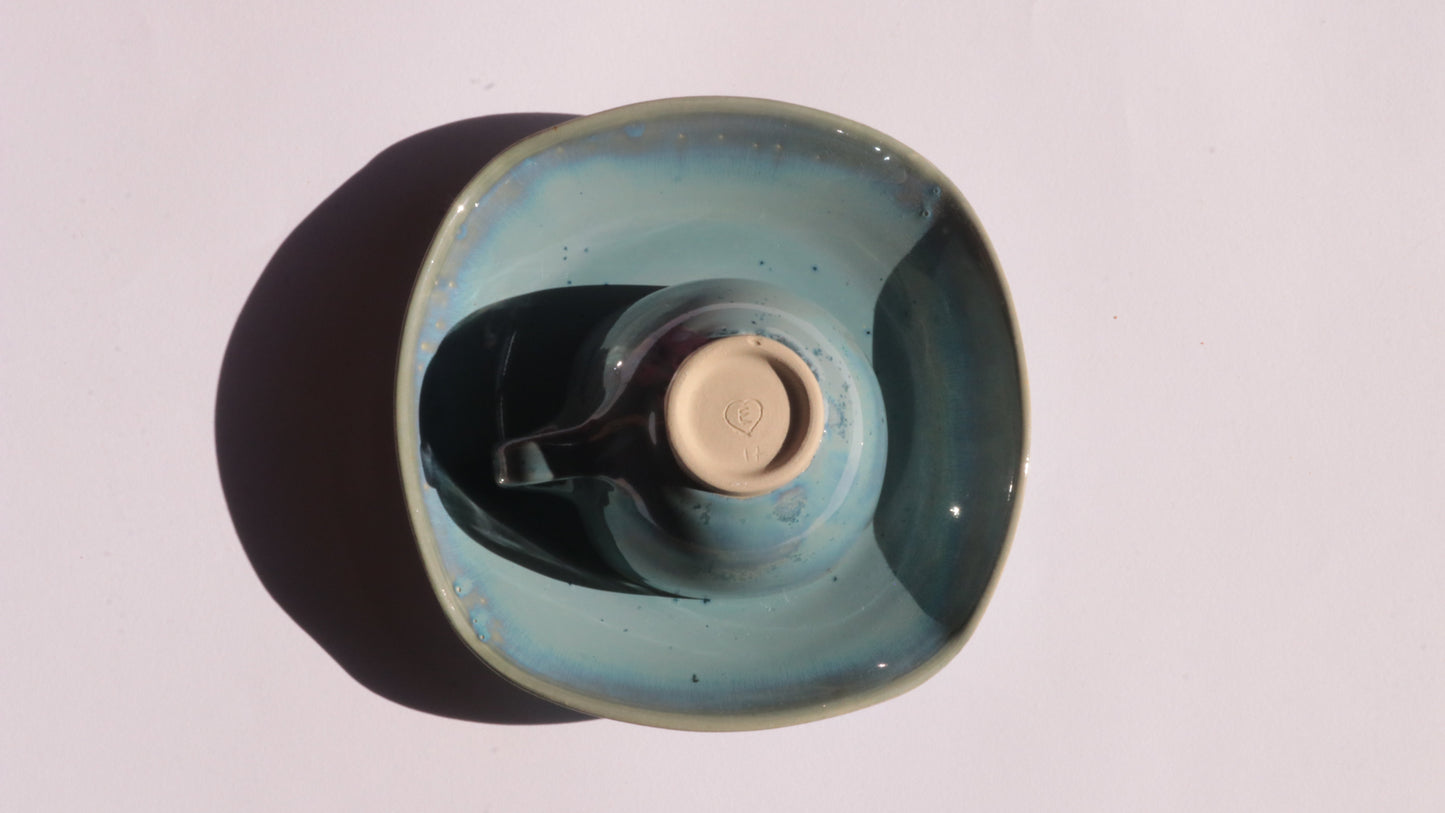Blue coffee cup and saucer with square rims on white background