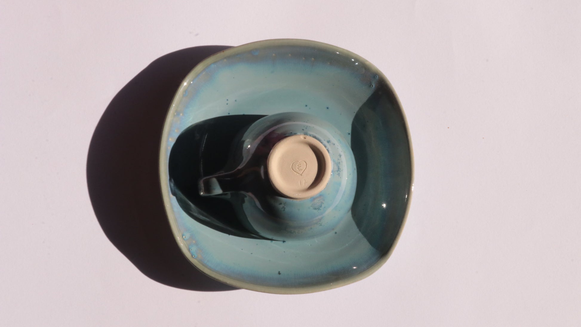 Blue coffee cup and saucer with square rims on white background