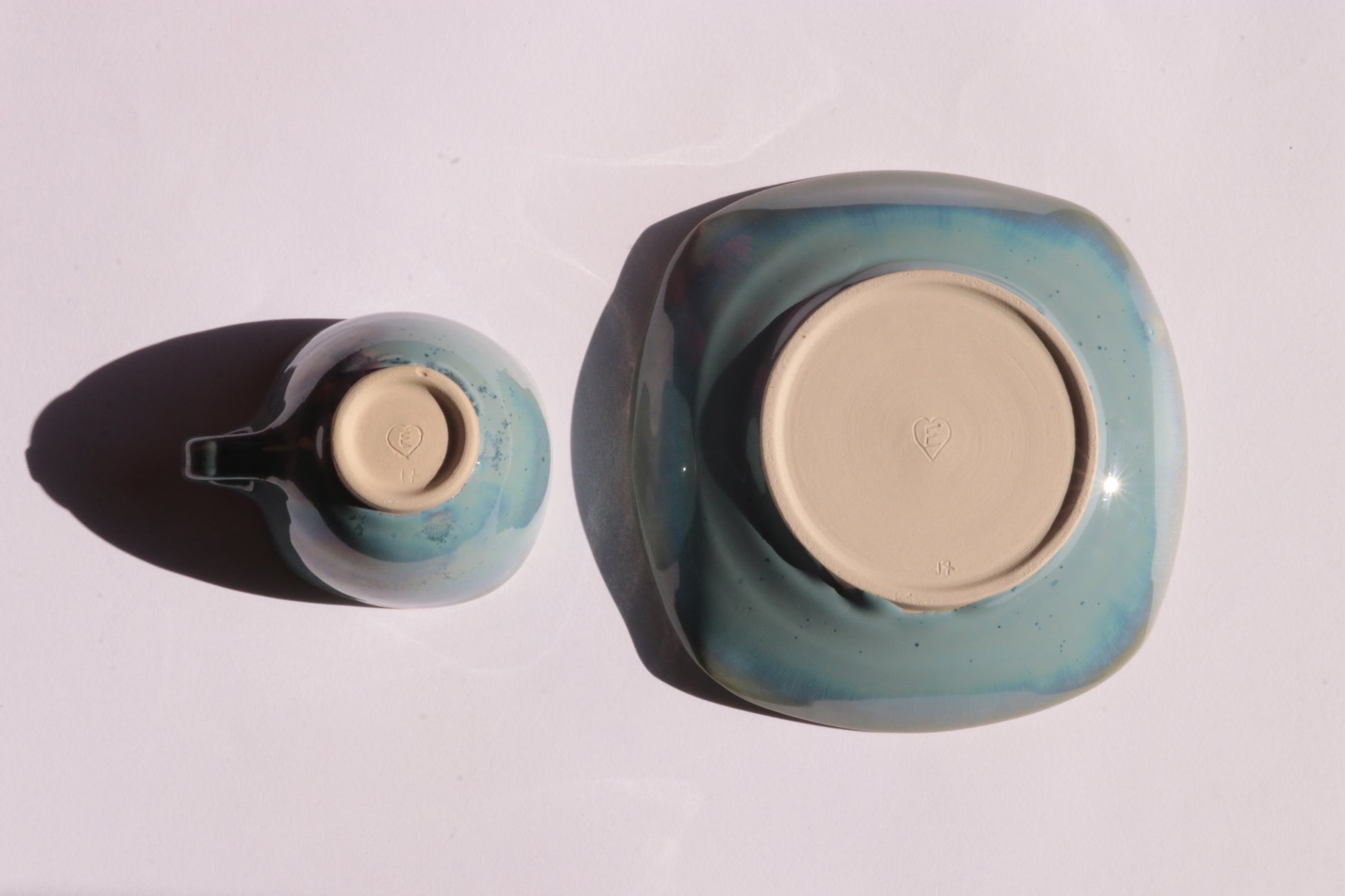 Blue coffee cup and saucer with square rims on white background