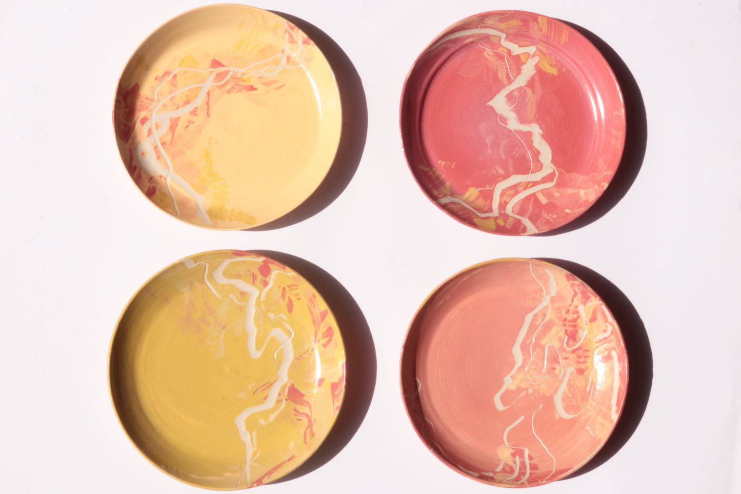 set of four colourful and engraved plates on white background