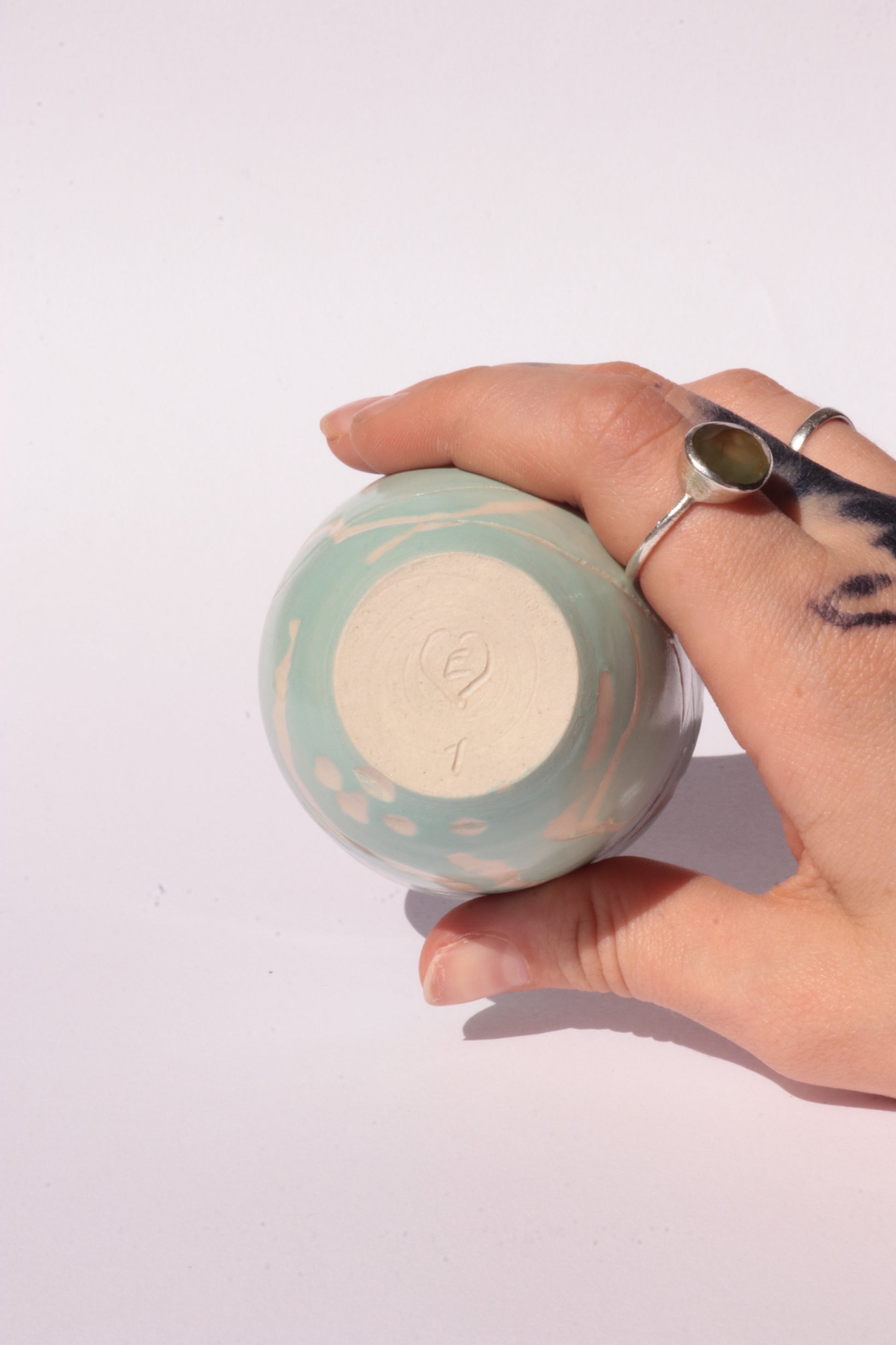 engraved light blue ceramic cup on white background