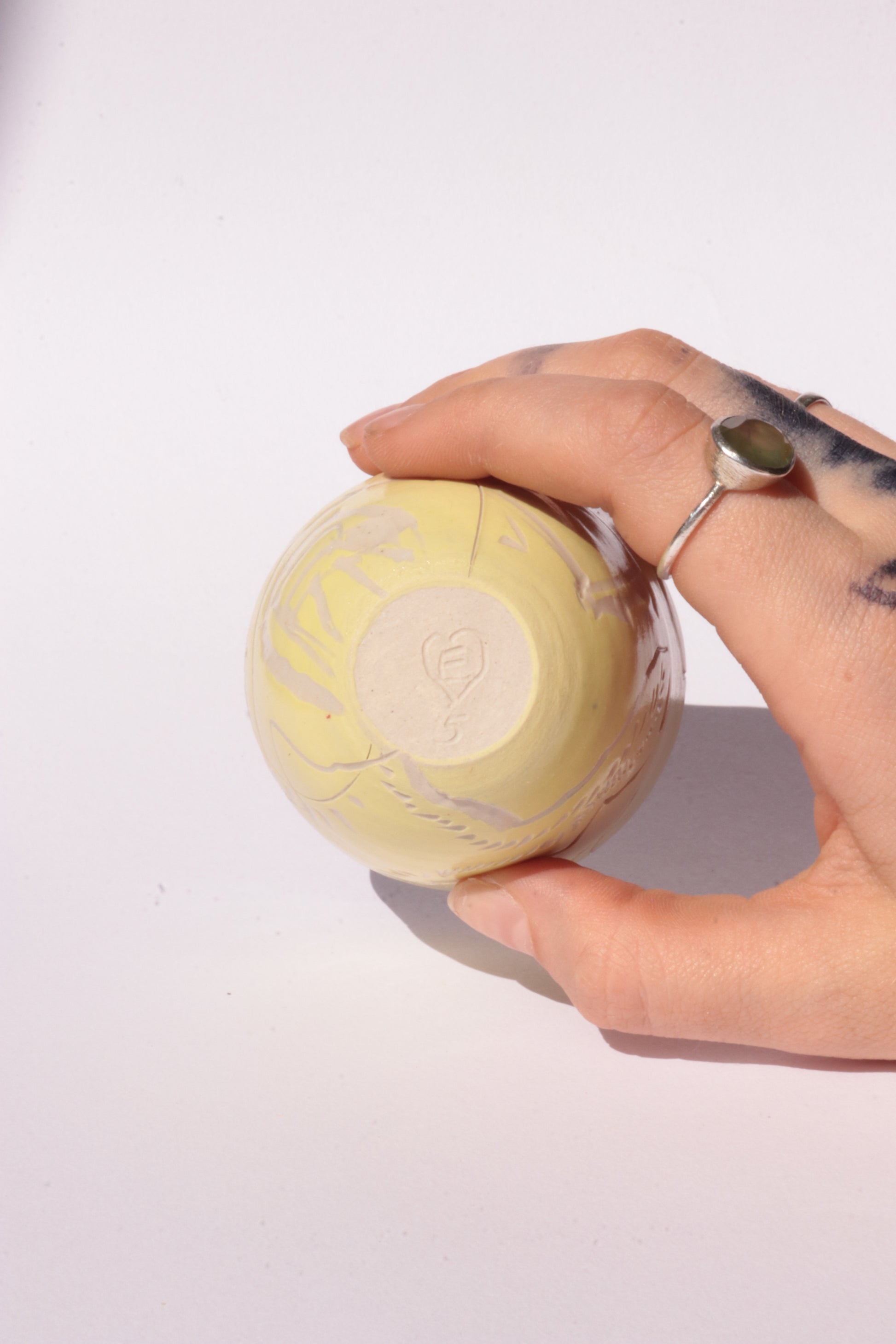 engraved yellow ceramic cup on white background