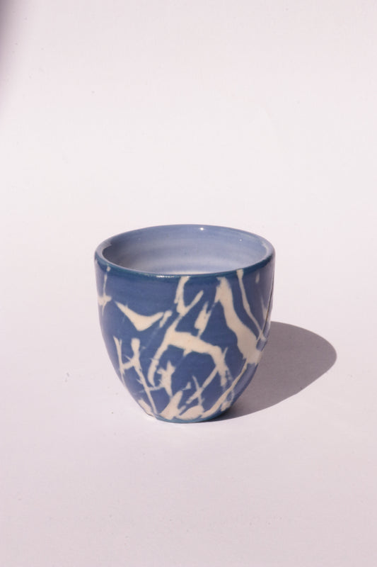 engraved dark blue ceramic cup on white background