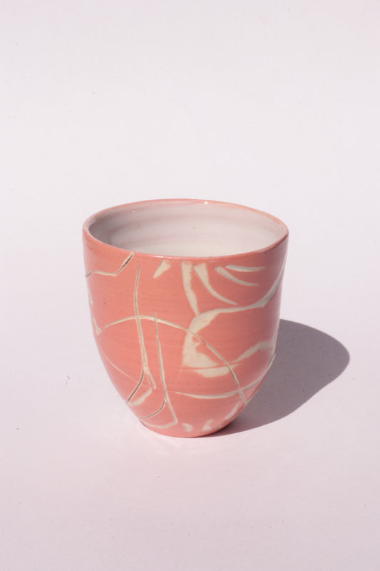 engraved orange ceramic cup on white background