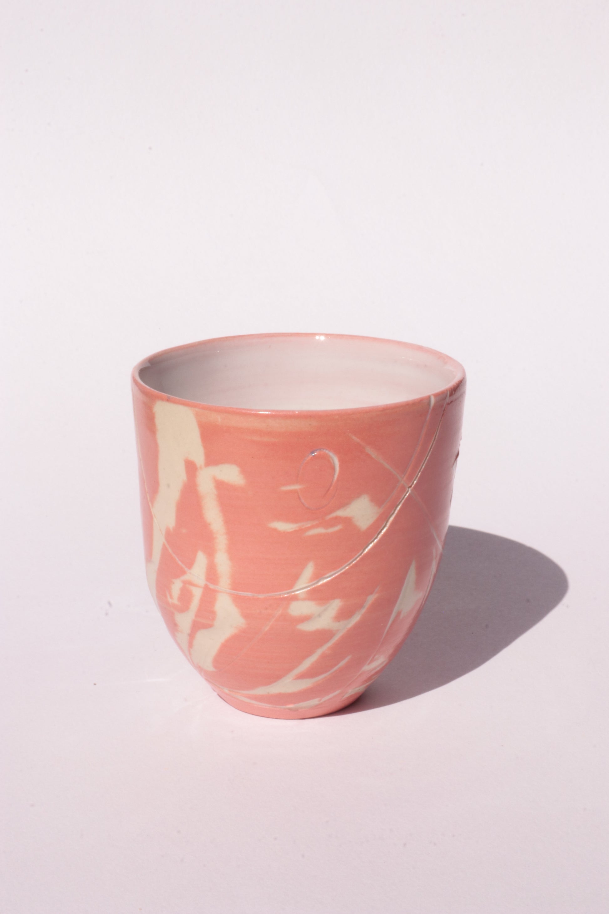 engraved orange ceramic cup on white background