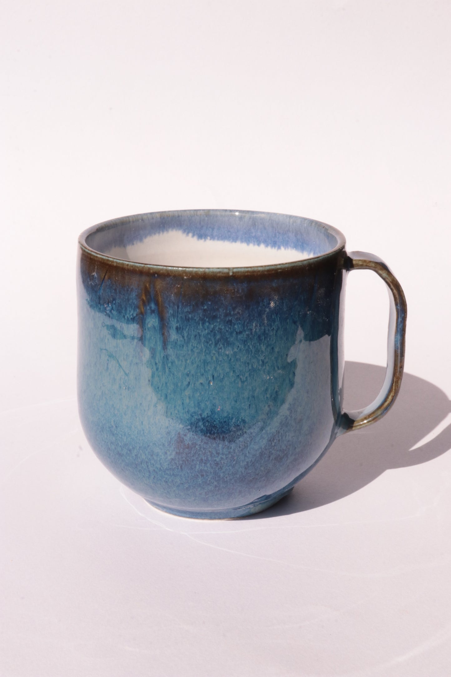 Dark blue mug with subtle engraved design on a white background