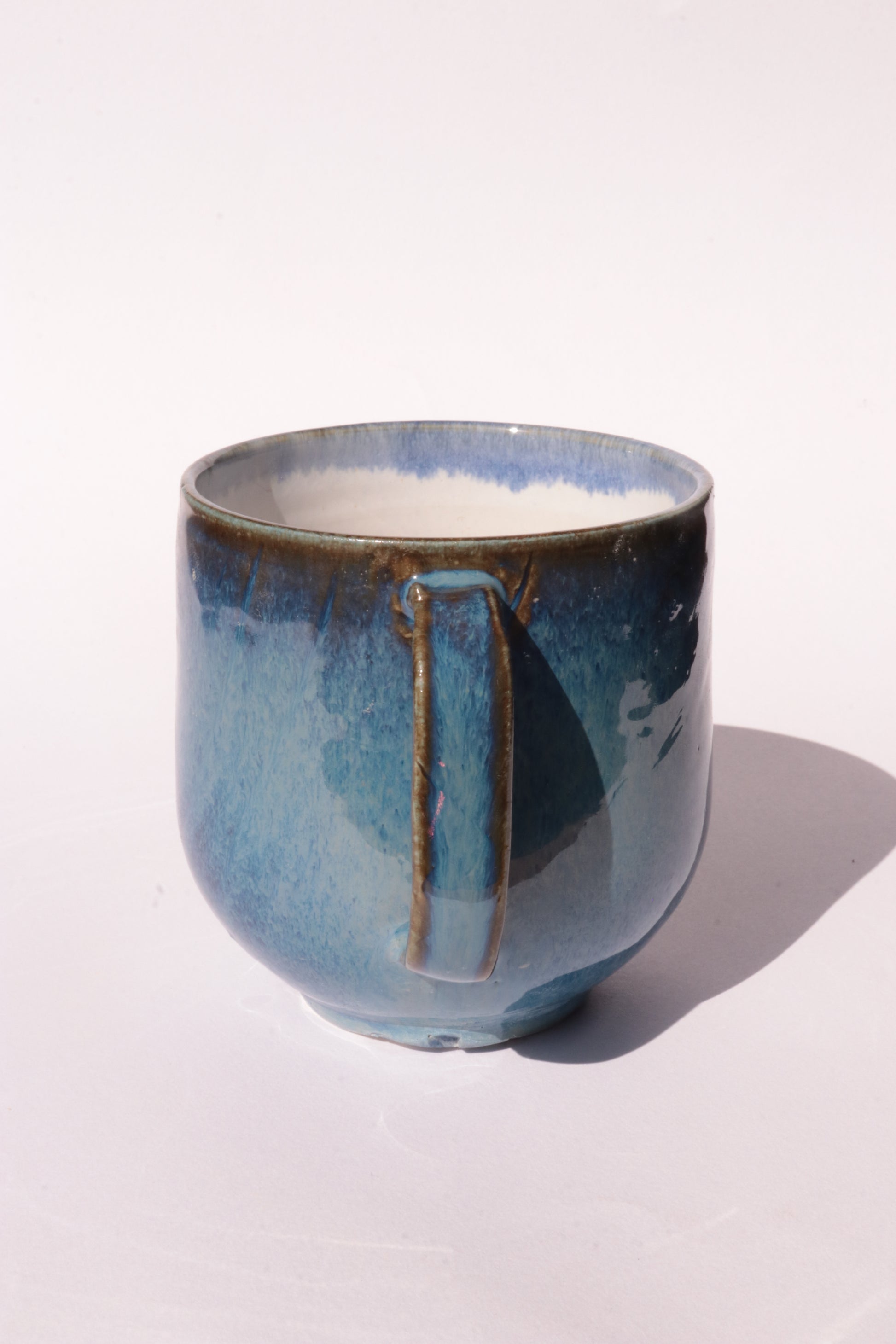 Dark blue mug with subtle engraved design on a white background