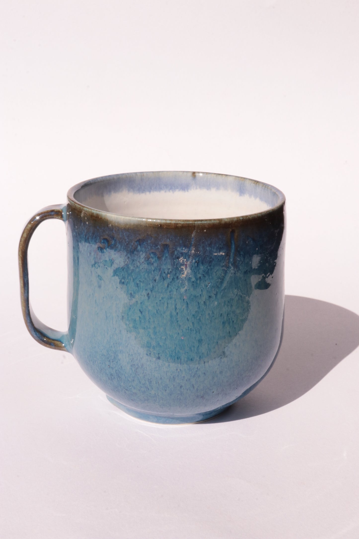 Dark blue mug with subtle engraved design on a white background