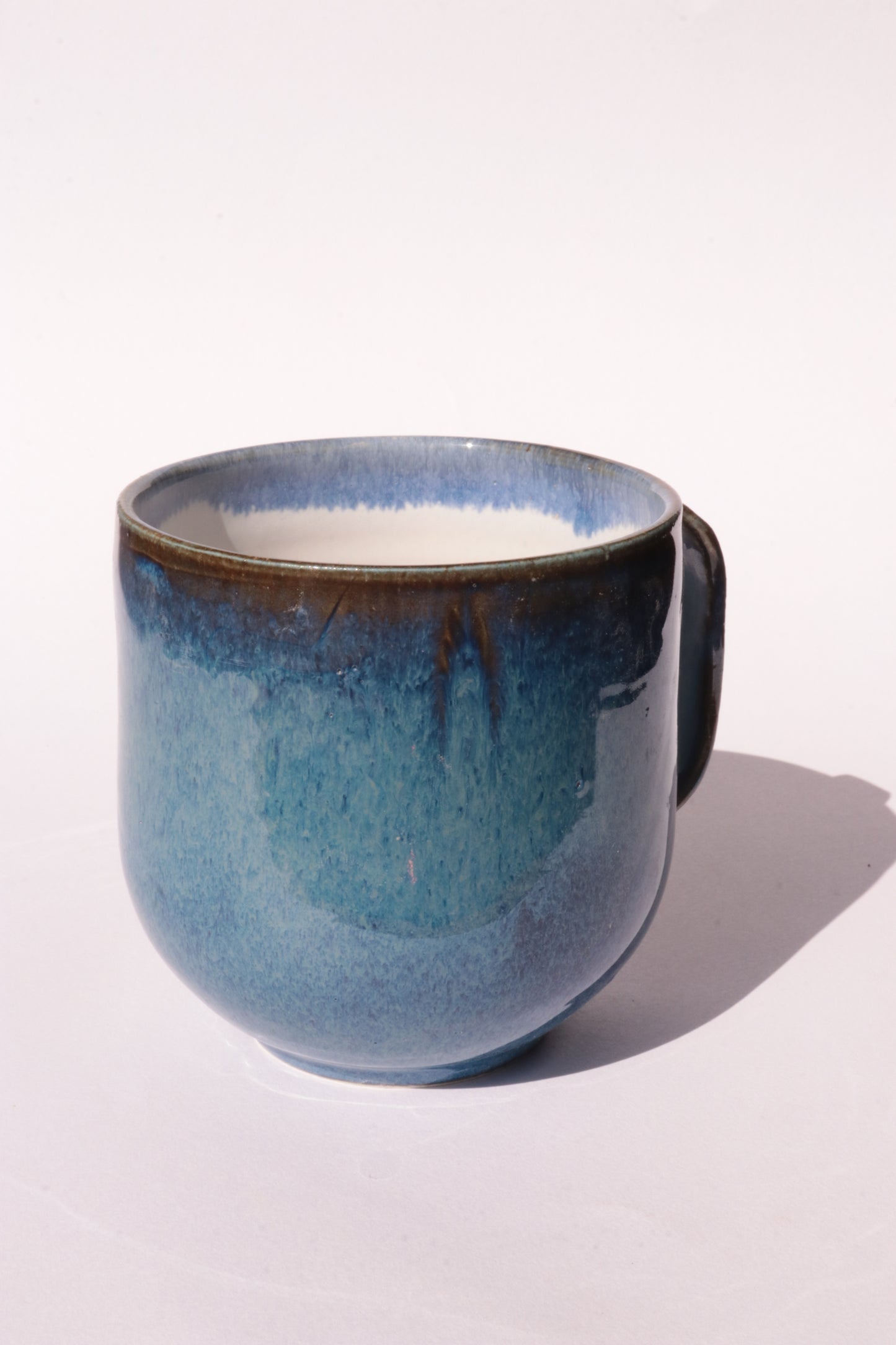 Dark blue mug with subtle engraved design on a white background