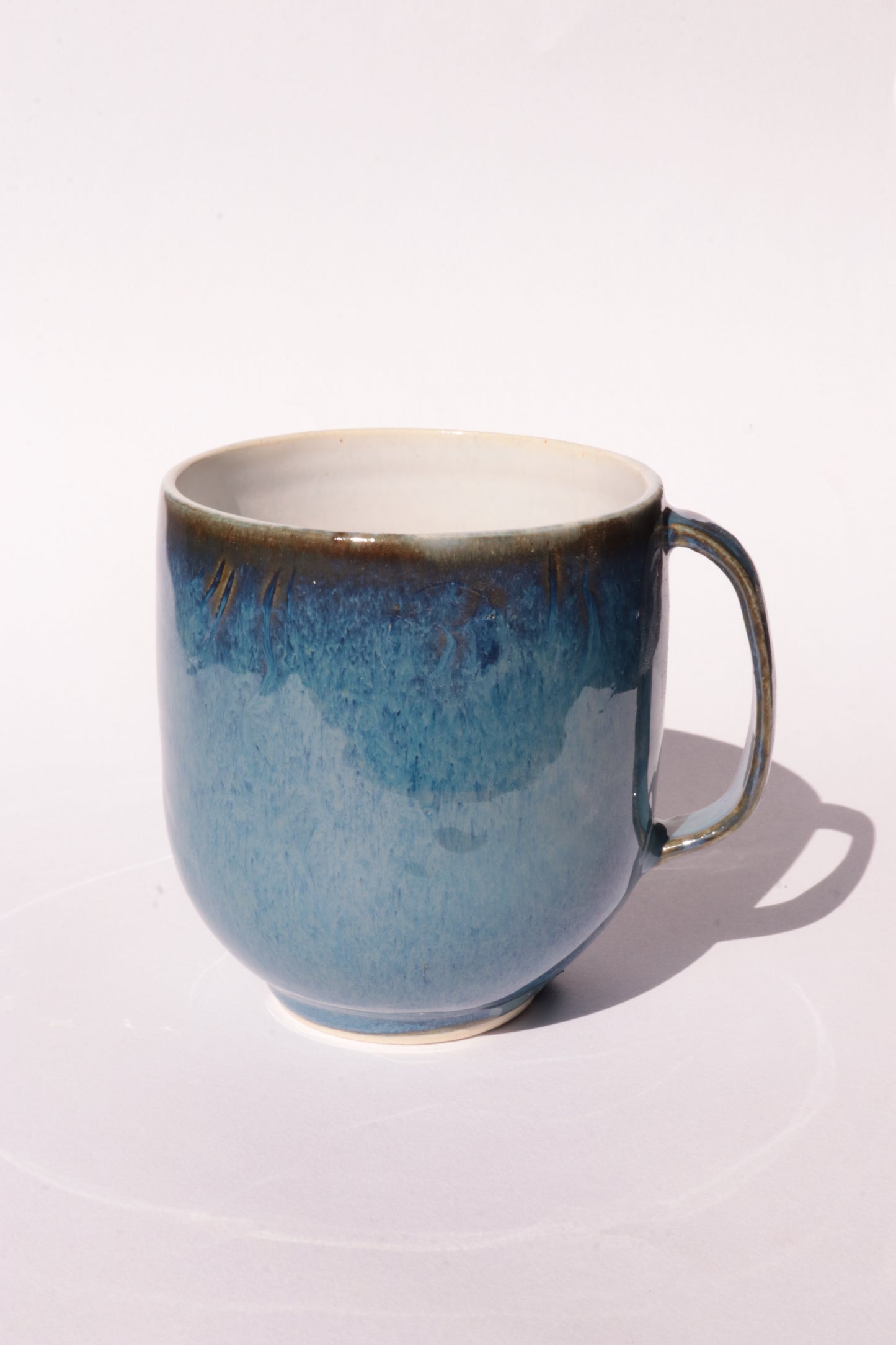 Dark blue mug with subtle engraved design on a white background