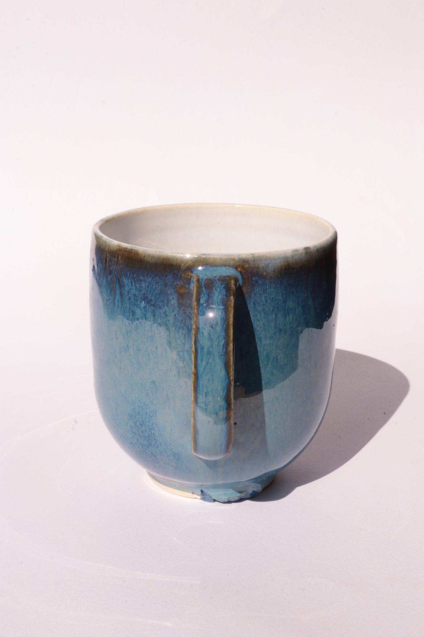 Dark blue mug with subtle engraved design on a white background