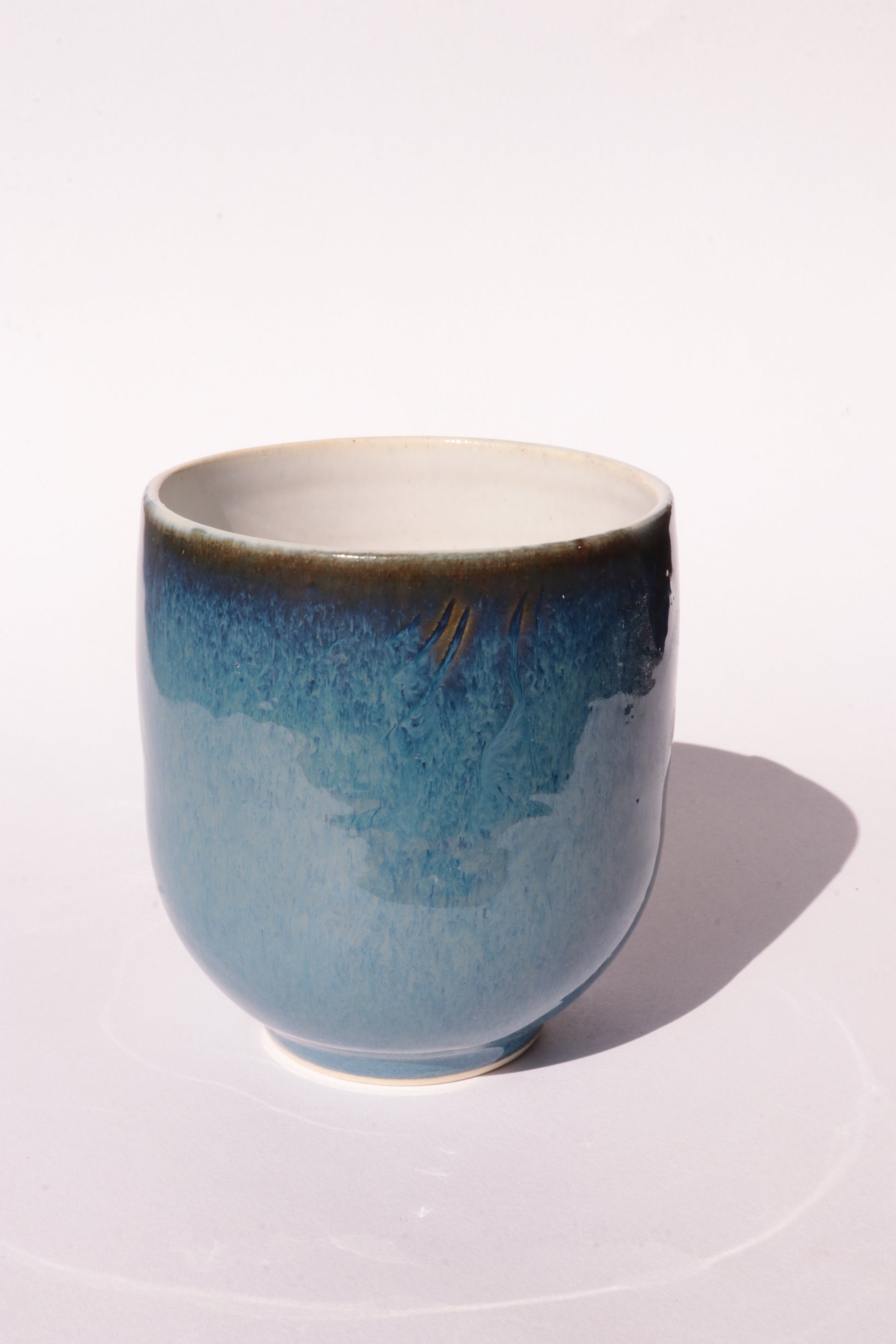 Dark blue mug with subtle engraved design on a white background