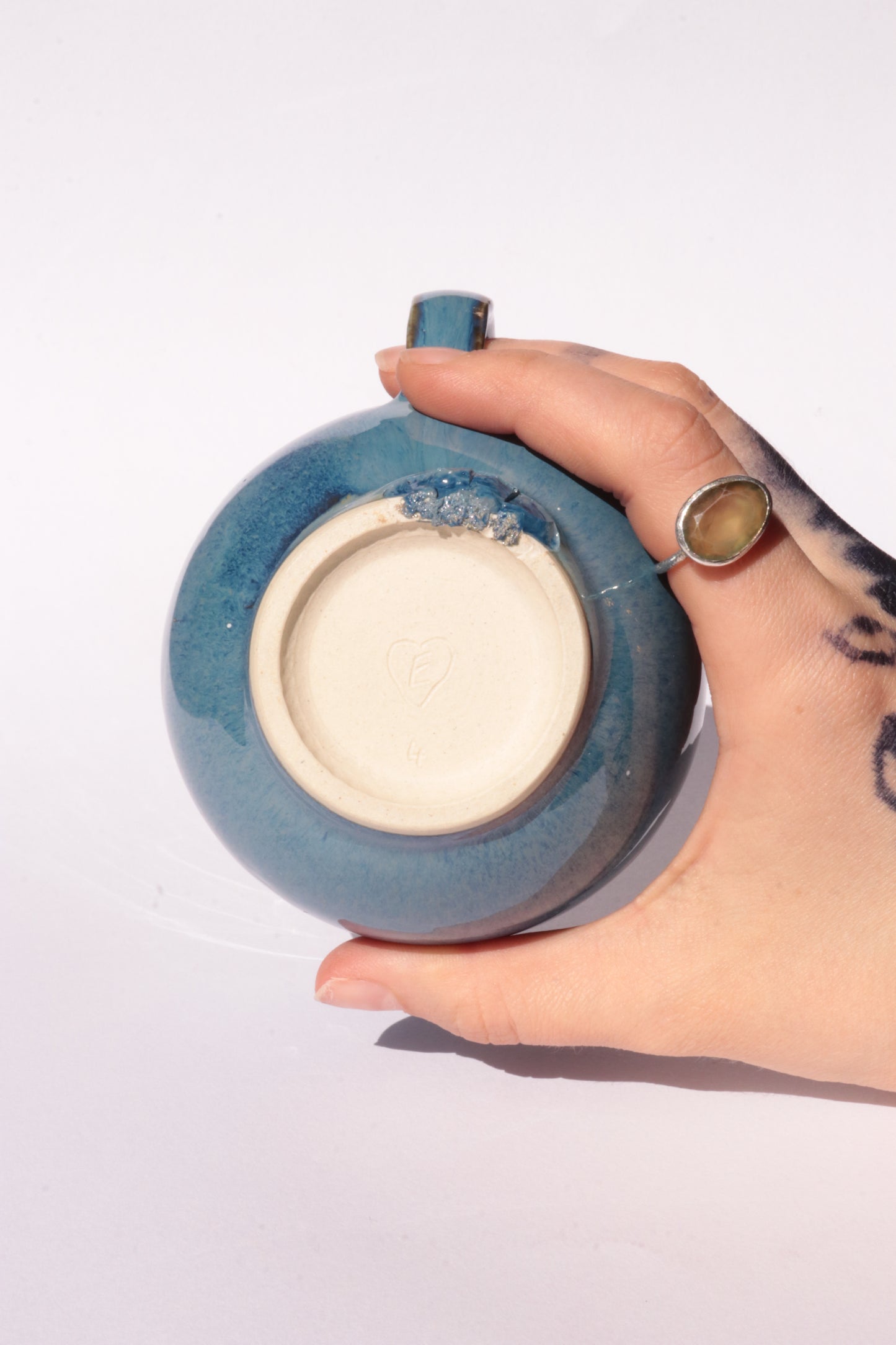 Dark blue mug with subtle engraved design on a white background