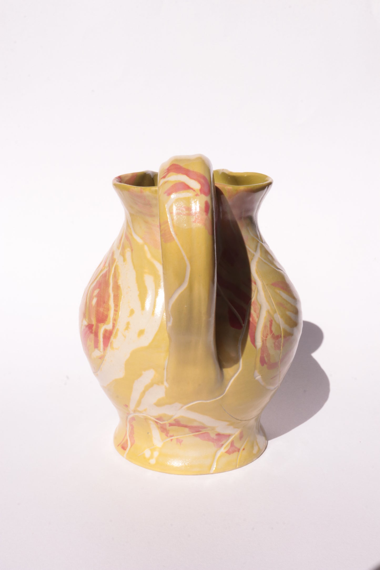 colourful engraved jug on white background
