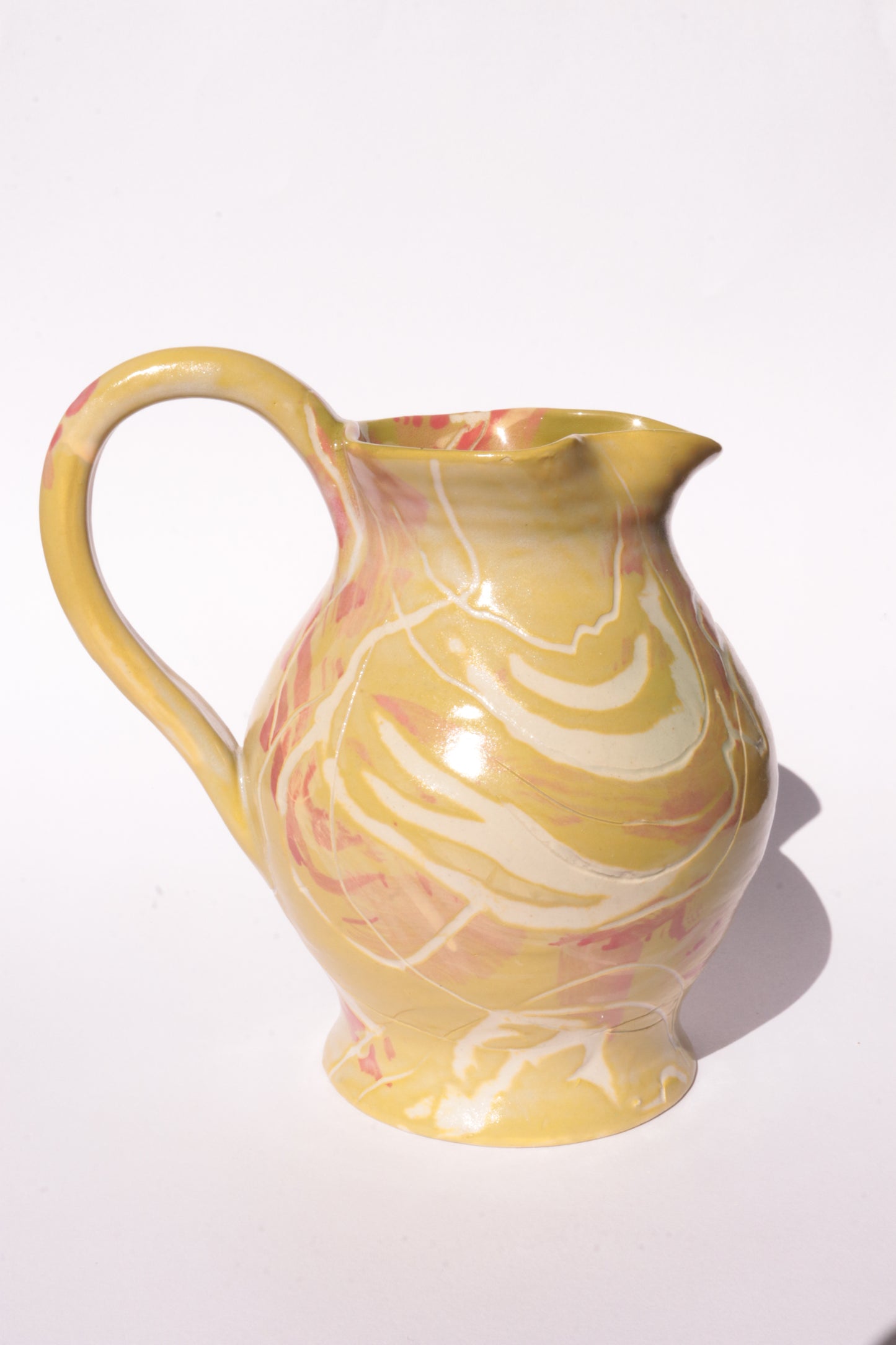 colourful engraved jug on white background