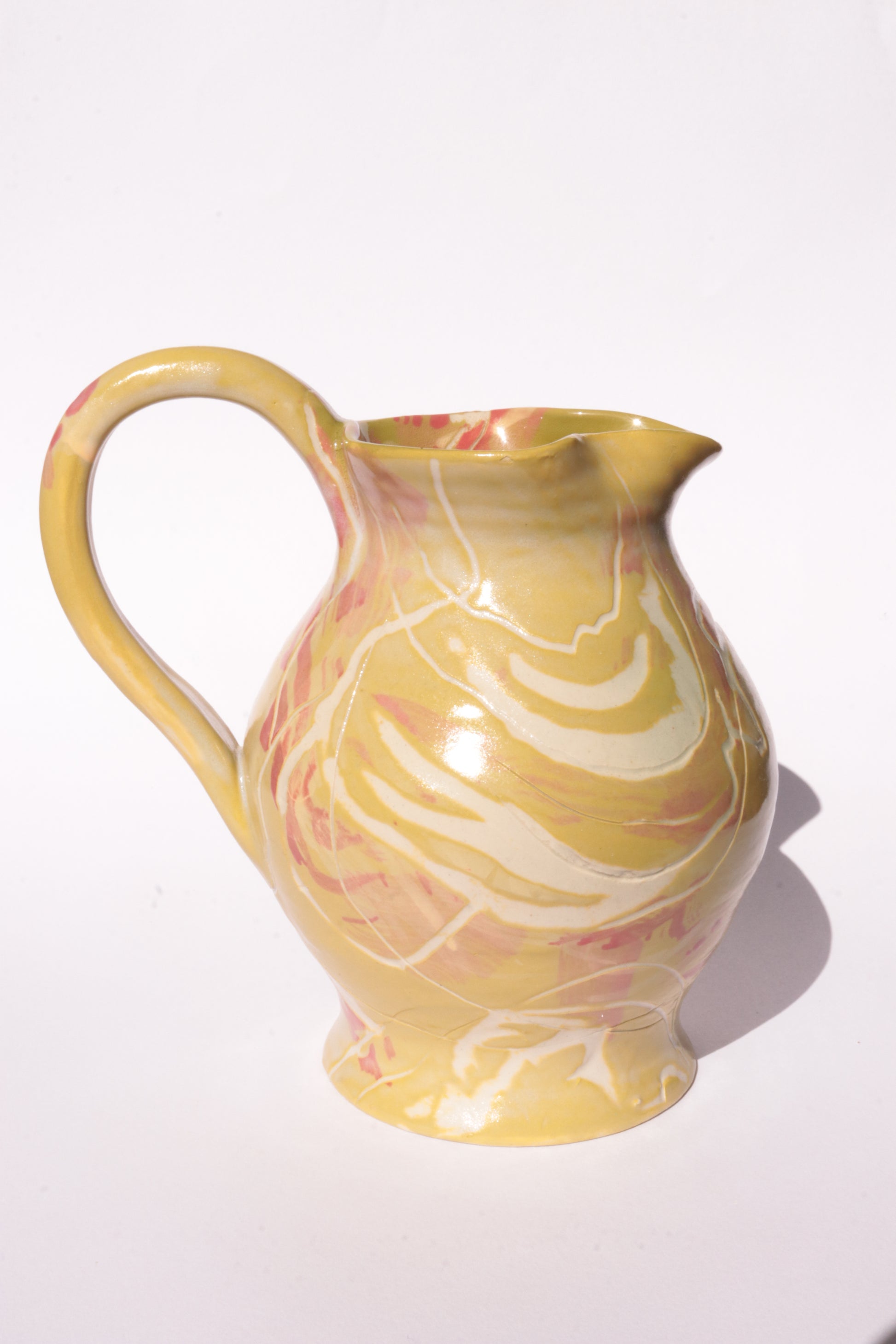 colourful engraved jug on white background