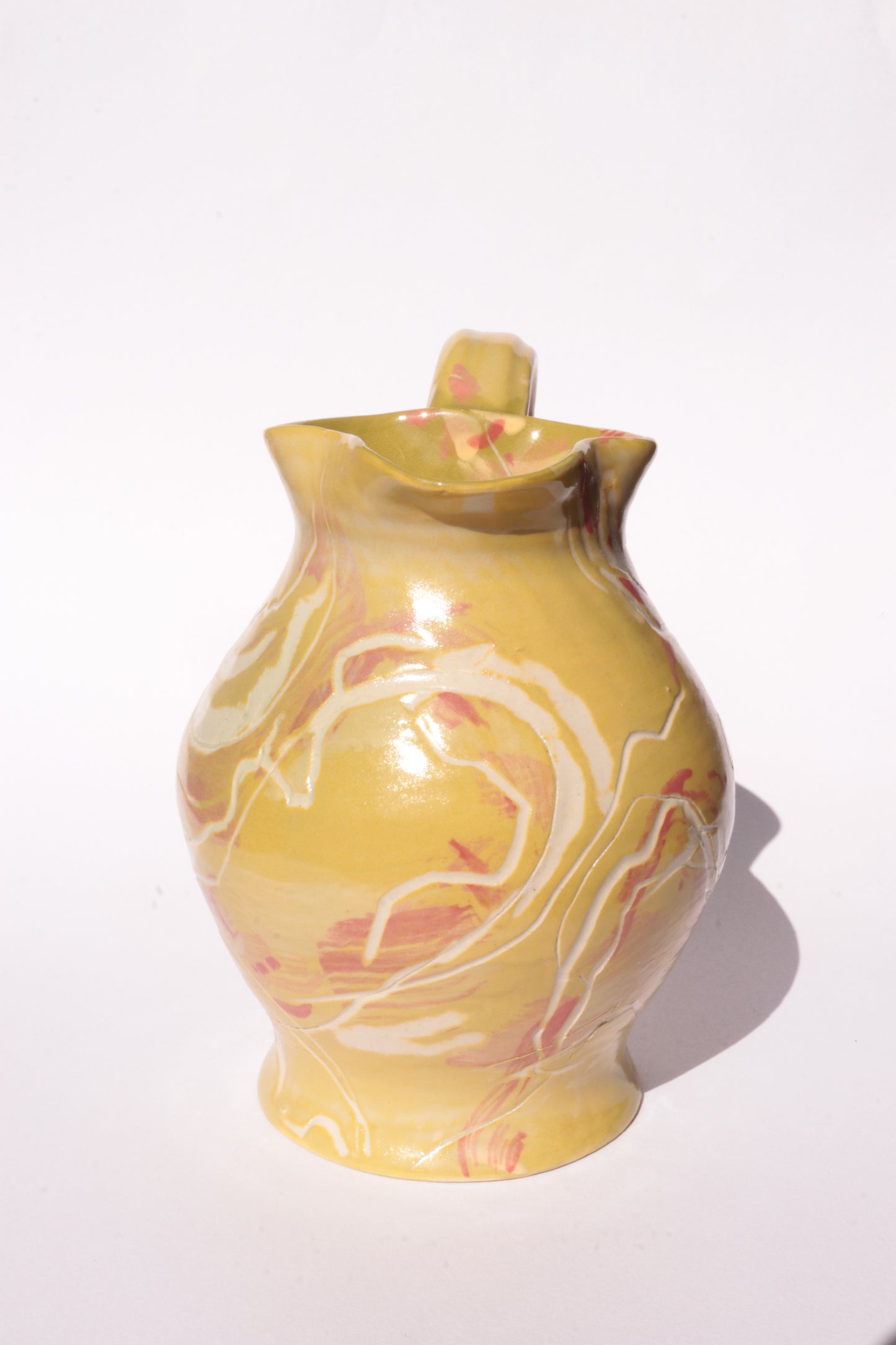 colourful engraved jug on white background